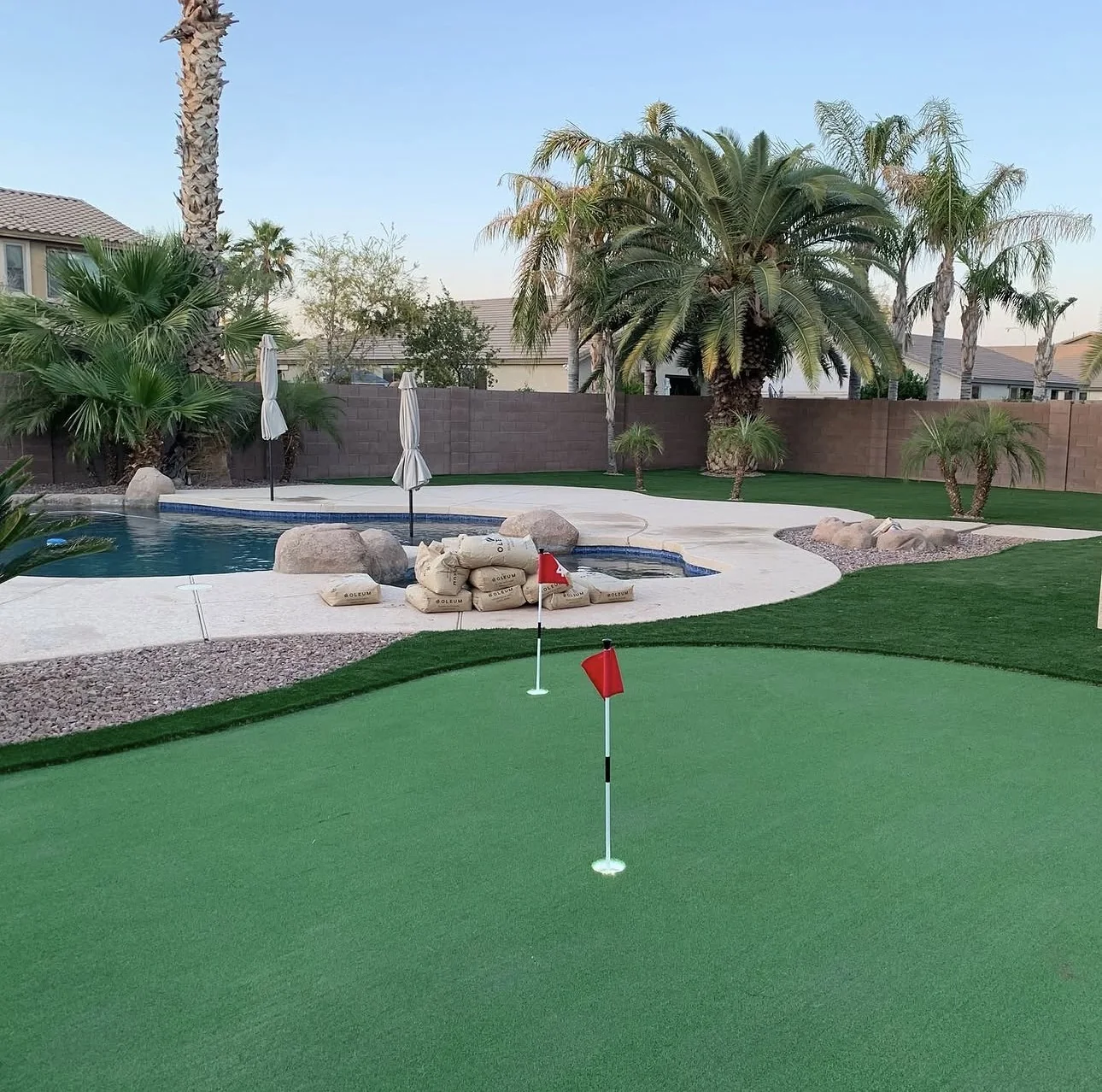 Green artificial turf surrounding a pool